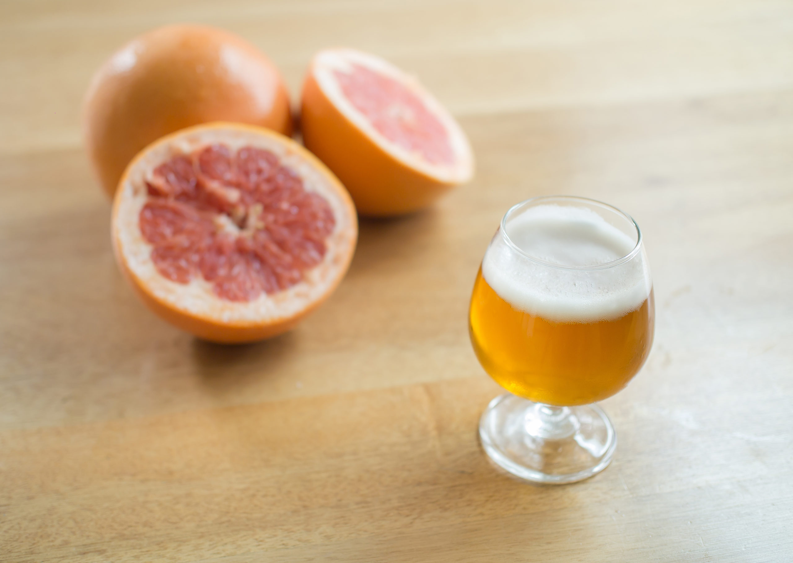 grapefruit and beer on table