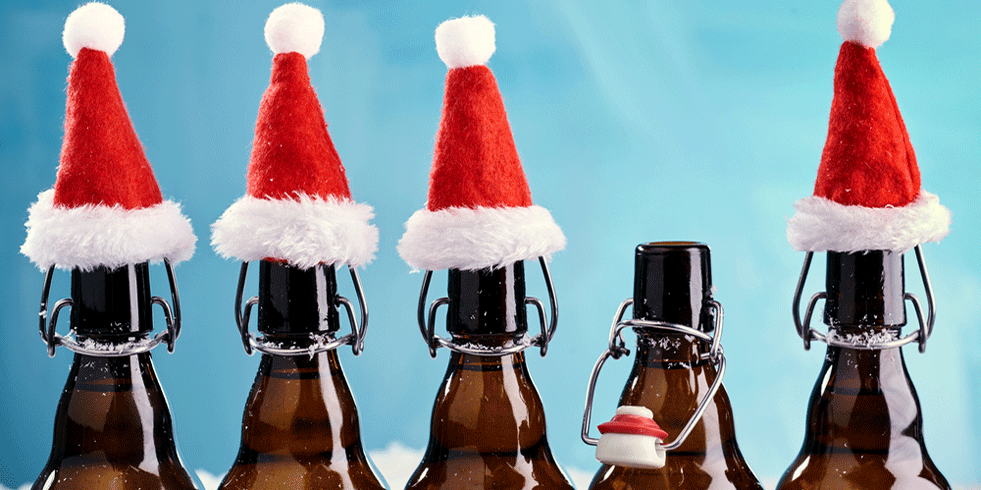 Beer bottles wearing Santa hats