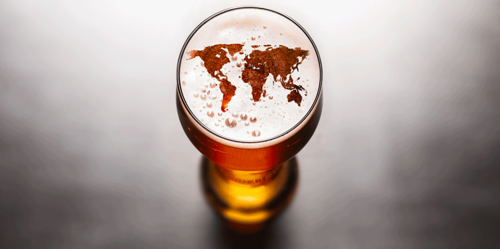 Beer glass with world map in foam